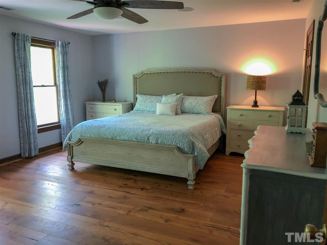101 Springbrook Place Cary, NC 27518 - Photo 15 of 26 a bedroom with a bed and window