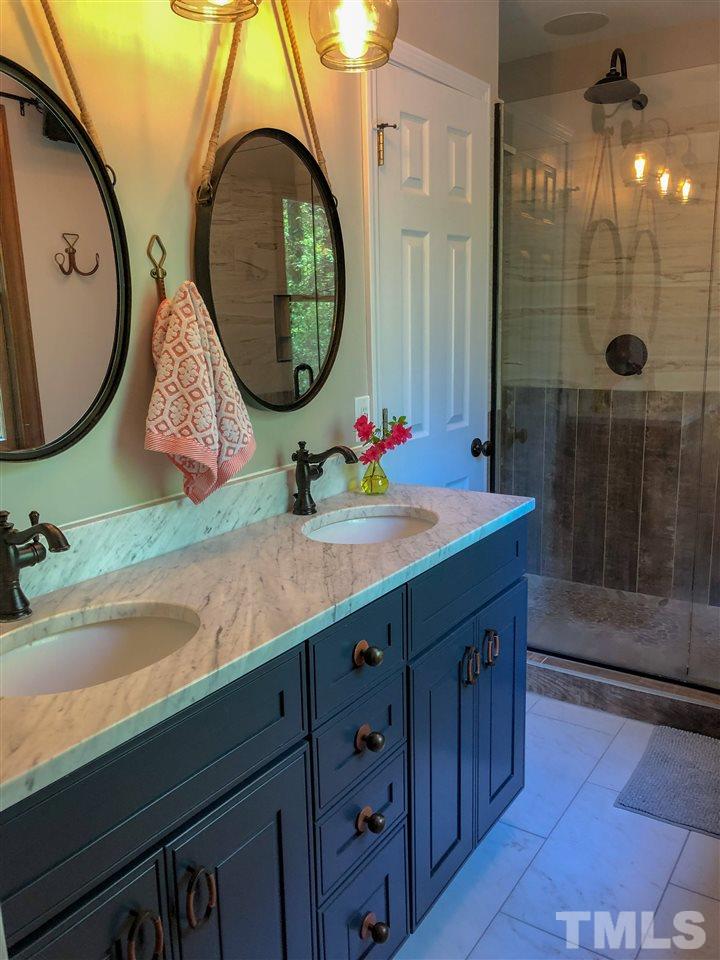 101 Springbrook Place Cary, NC 27518 - Photo 16 of 26 a bathroom with a sink and a mirror