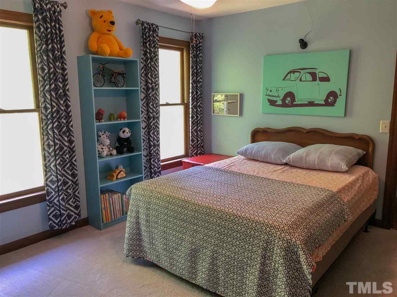 101 Springbrook Place Cary, NC 27518 - Photo 18 of 26 a bedroom with a bed and a window