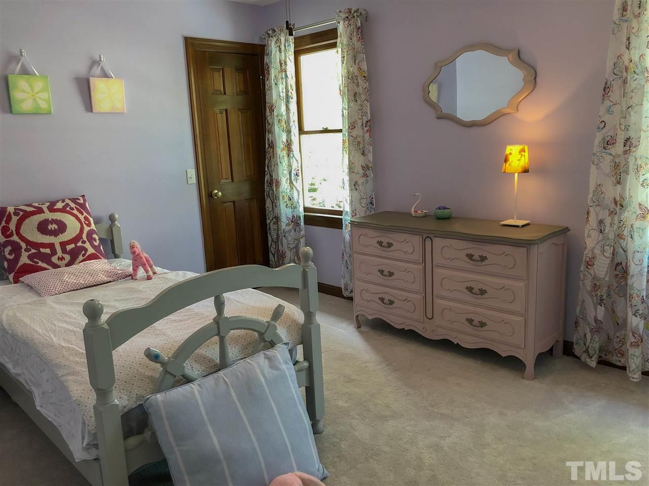 101 Springbrook Place Cary, NC 27518 - Photo 19 of 26 a bedroom with a bed and a dresser