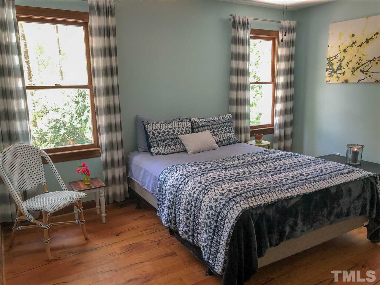 101 Springbrook Place Cary, NC 27518 - Photo 21 of 26 a bedroom with a bed a chair and next to a window