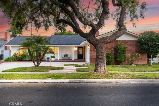 a view of a house with garden and trees