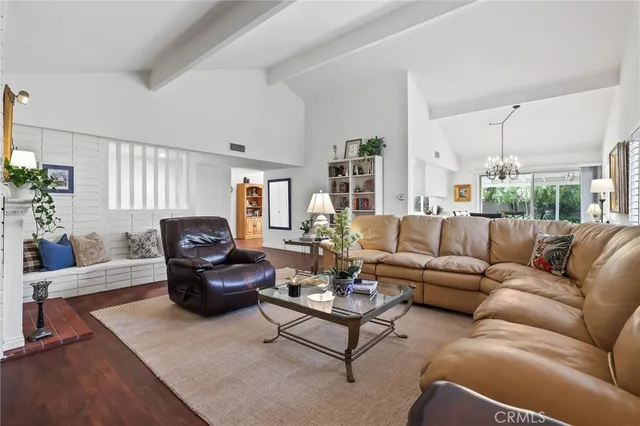 a living room with furniture rug and a large window