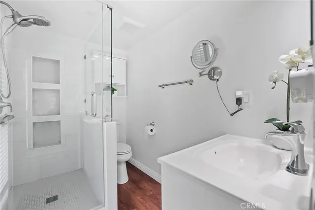 a bathroom with a sink a toilet and shower