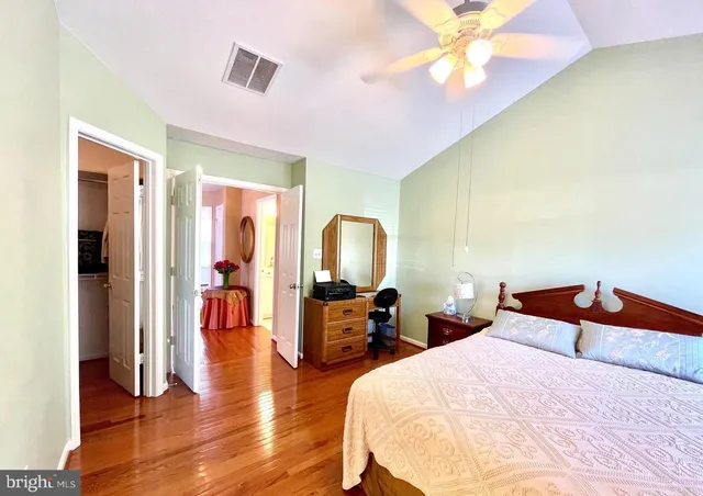 a bedroom with bed and wooden floor