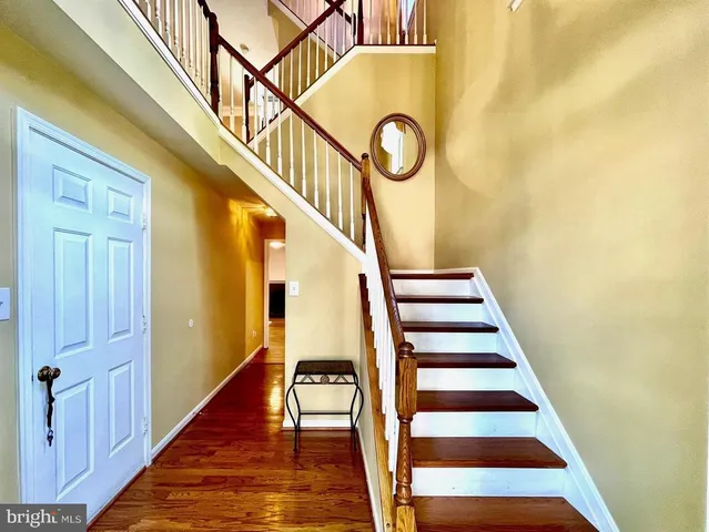 a view of entryway and hall with wooden floor