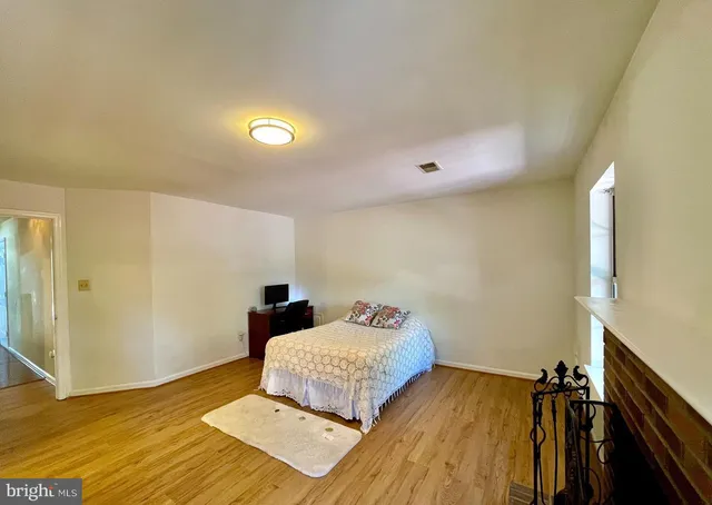 a bedroom with a bed and a night stand