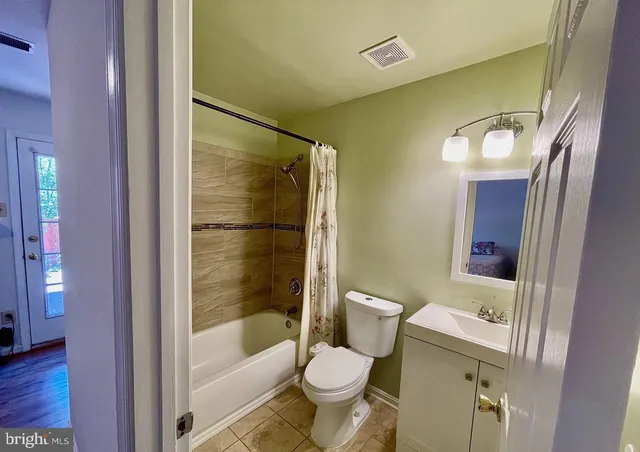 a bathroom with a shower and a toilet