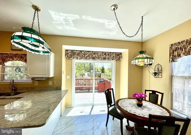 a dining room with furniture and a floor to ceiling window
