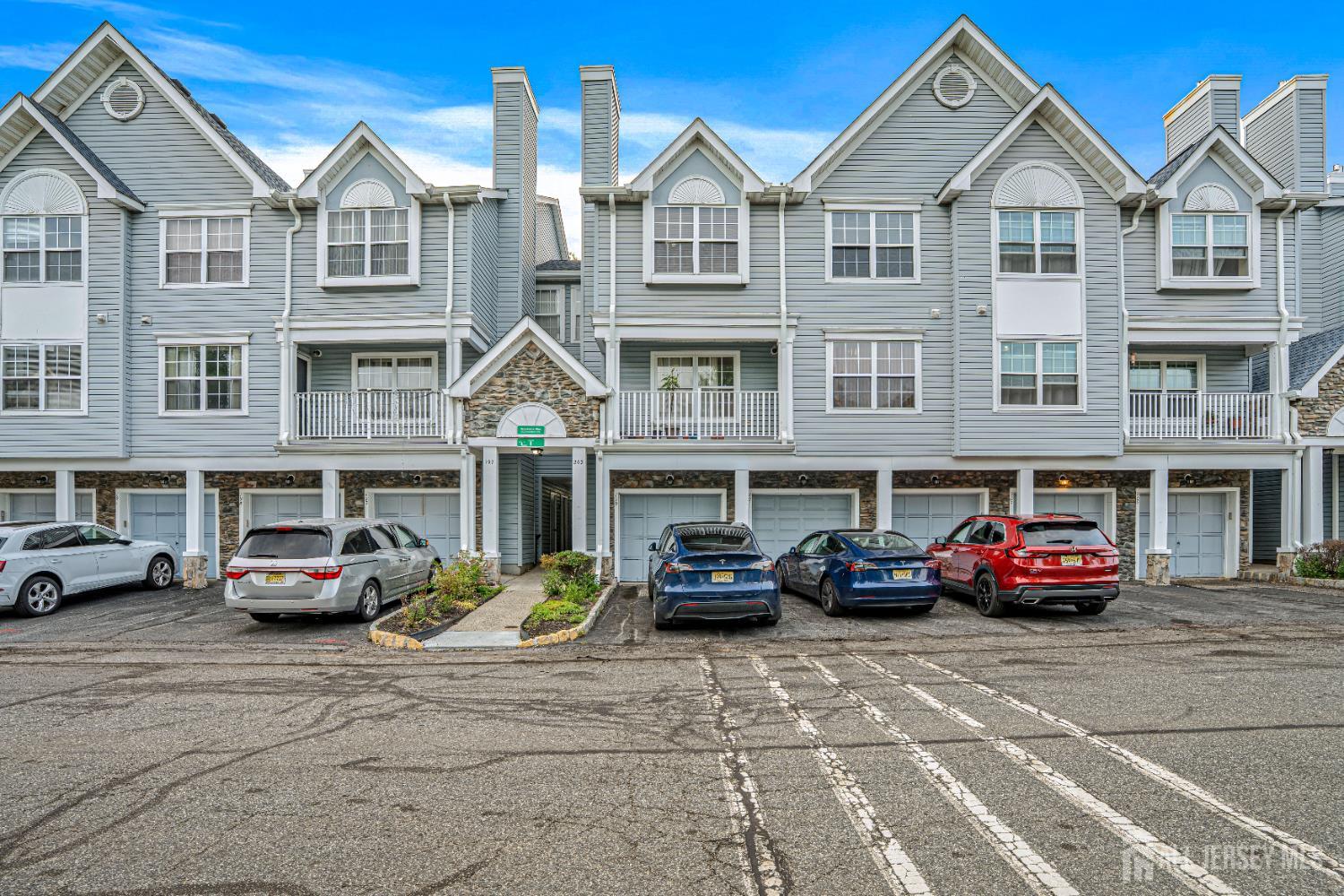 199 Prestwick Way Edison, NJ 08820 - Photo 1 of 1 a front view of a residential apartment building with cars parked