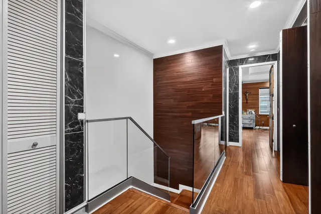 a room with furniture a baby crib and a wooden floor