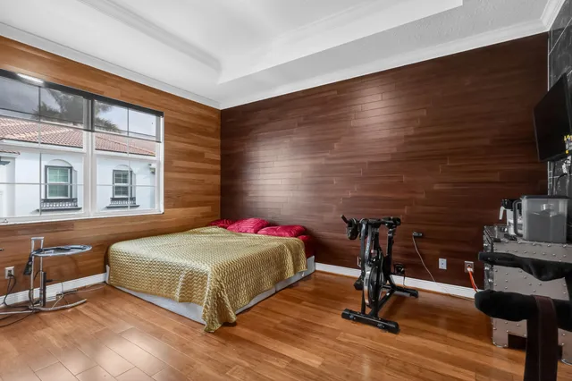 a bedroom with a bed and wooden floor