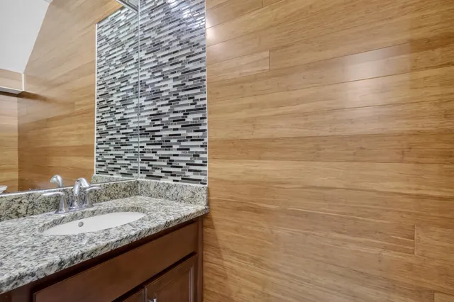 a kitchen with refrigerator and chairs