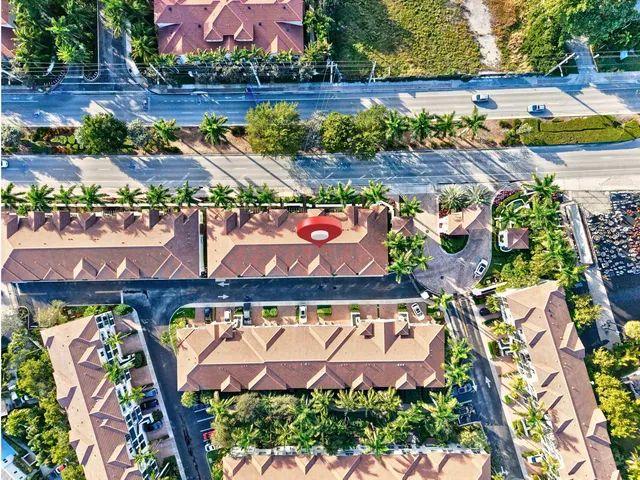 front view of a house with a yard and potted plants