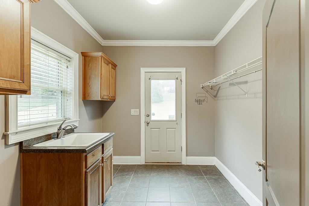 940 Chateau Forest Road Hoschton, GA 30548 - Photo 30 of 87 a bathroom with a sink and a mirror
