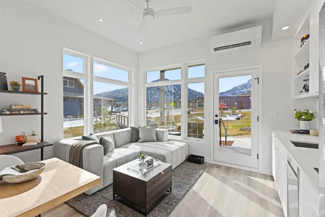 a living room with furniture and a floor to ceiling window