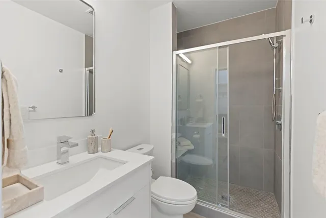 a bathroom with a sink toilet and shower