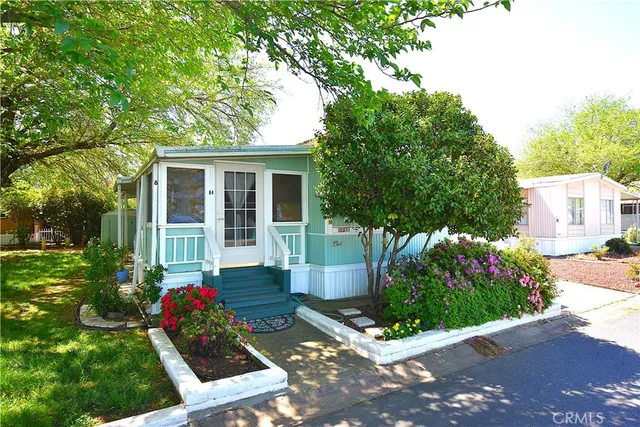 a front view of a house with a yard and potted plants