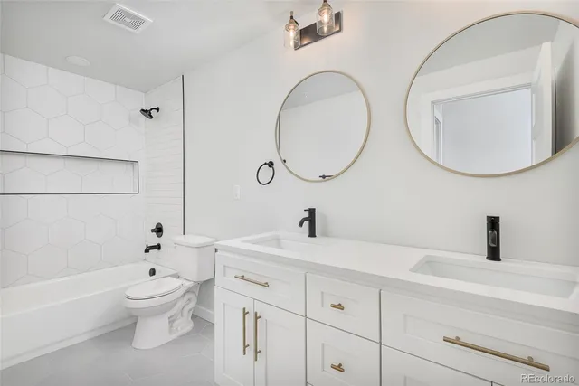 a bathroom with a toilet a sink and a mirror