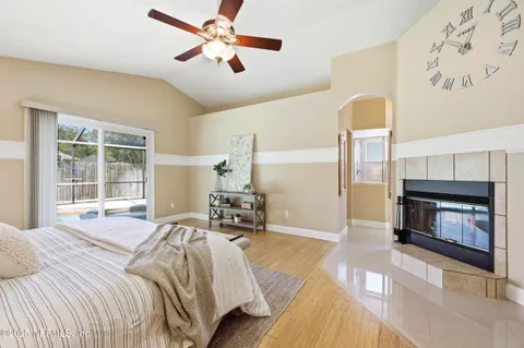 a bedroom with a bed and a fireplace