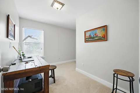 a utility room with dryer washer and a view of bathroom