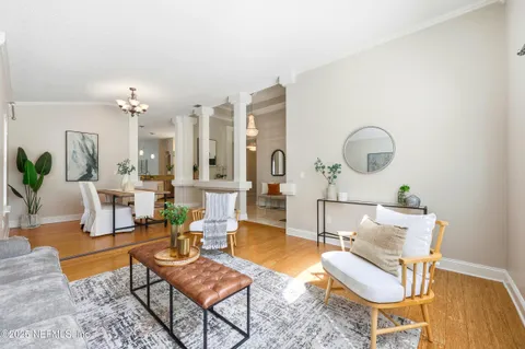 a living room with furniture a rug and a chandelier