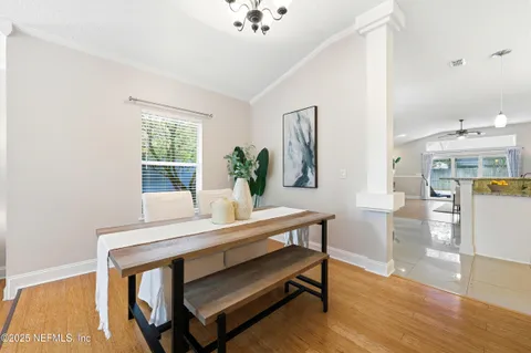 a view of a dining room with furniture and wooden floor