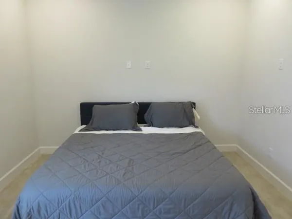 a bathroom with a granite countertop sink toilet a mirror and shower