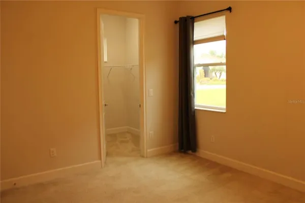 a bathroom with a granite countertop sink toilet a mirror and shower