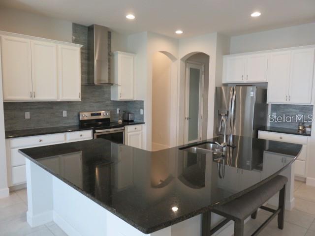 6969 Indus Valley Circle Parrish, FL 34219 - Photo 4 of 49 a kitchen with stainless steel appliances granite countertop a sink a microwave and a refrigerator