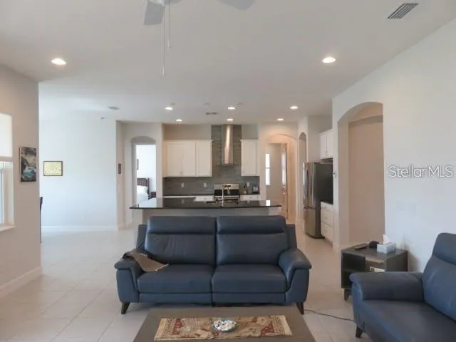 a view of a living room kitchen and a wooden floor