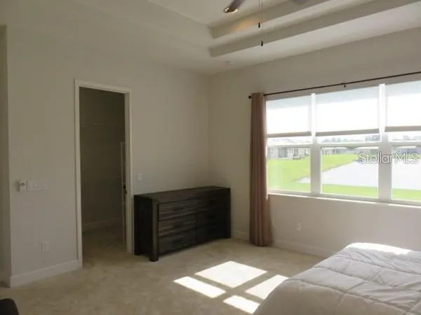 a bed room with a bed and a window