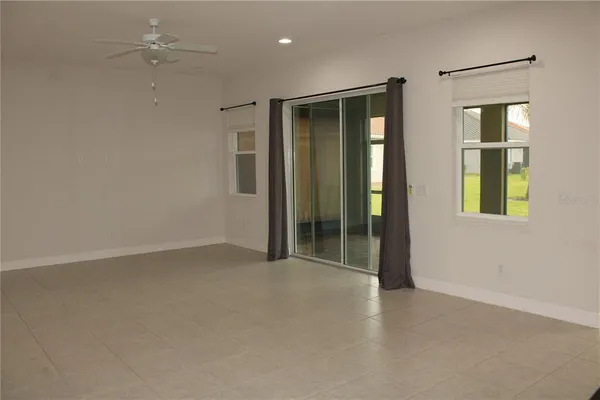 an empty room with windows and closet