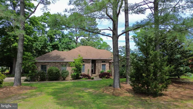 a view of a patio with a table and chairs under an umbrella