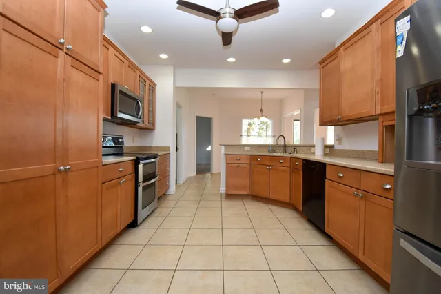 a kitchen with stainless steel appliances granite countertop a sink counter space cabinets and a window