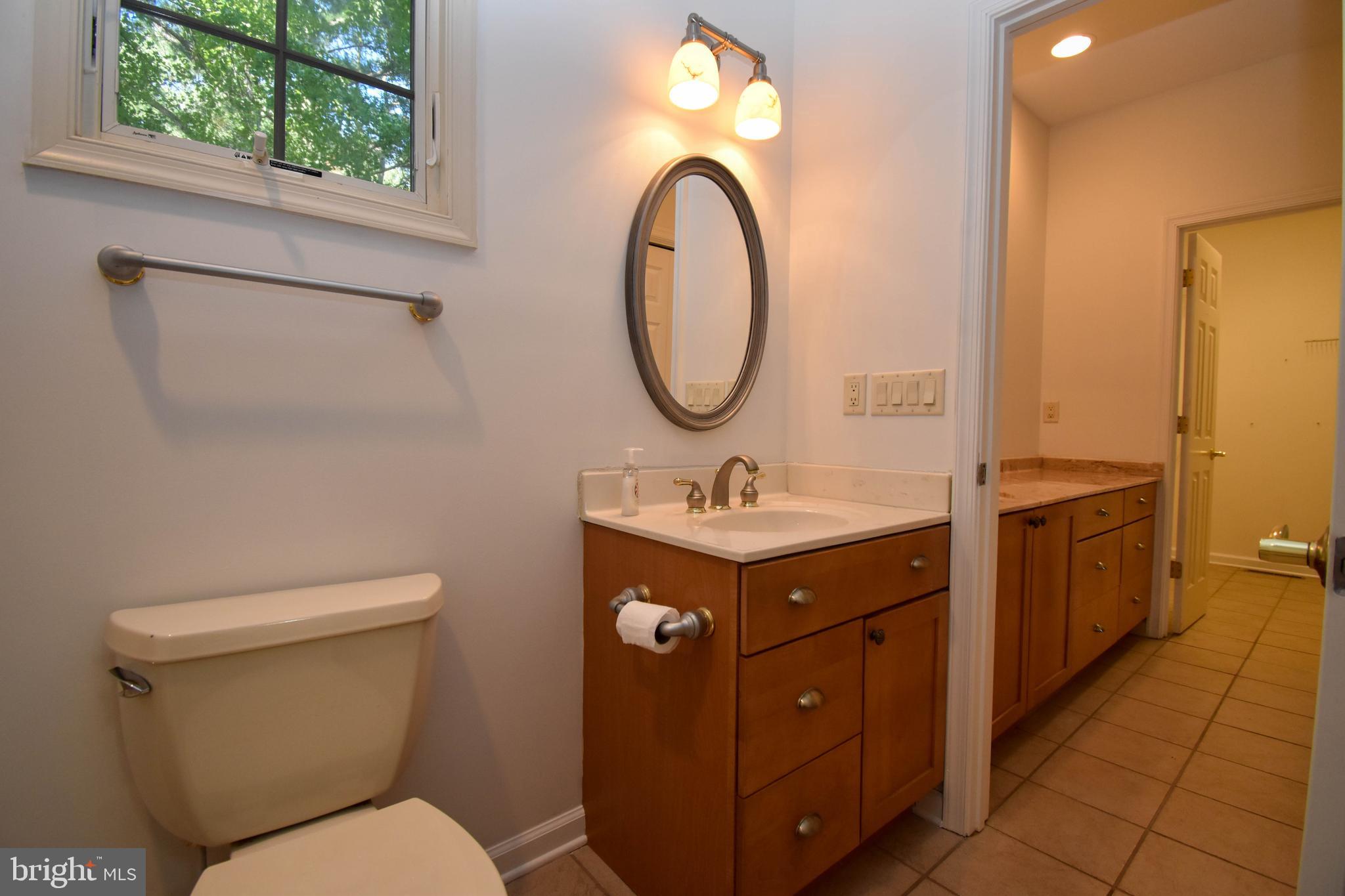 1 Bay Point Road Millsboro, DE 19966 - Photo 16 of 26 a bathroom with a toilet sink and mirror