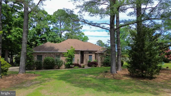 a view of a house with a yard and sitting area