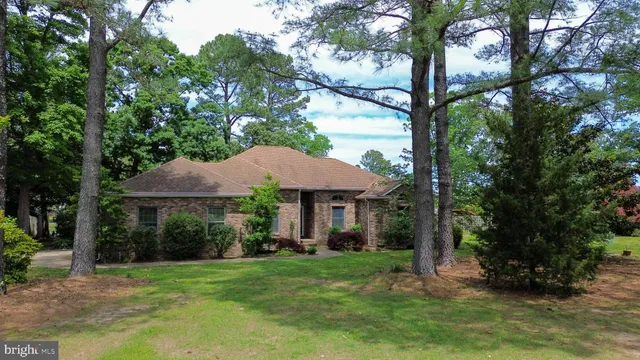 a view of a house with a yard and sitting area
