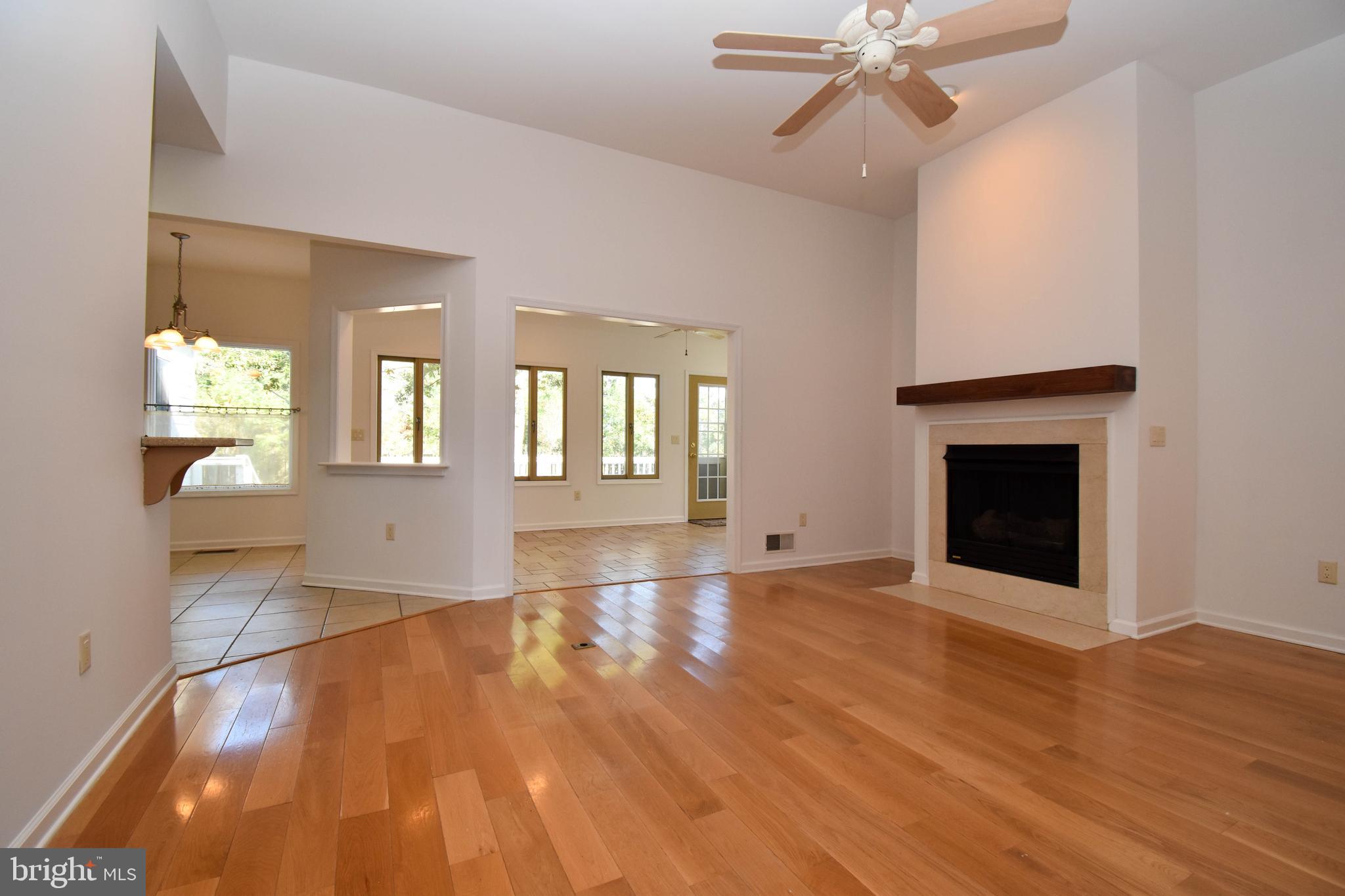 1 Bay Point Road Millsboro, DE 19966 - Photo 6 of 26 an empty room with wooden floor fan and windows