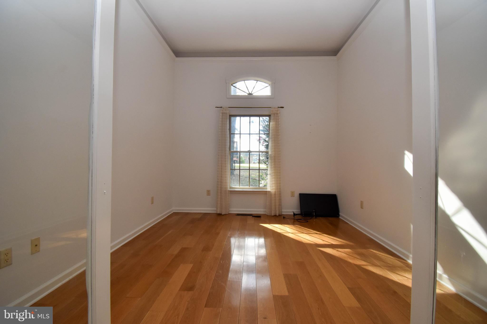 1 Bay Point Road Millsboro, DE 19966 - Photo 9 of 26 a view of empty room with wooden floor and fan