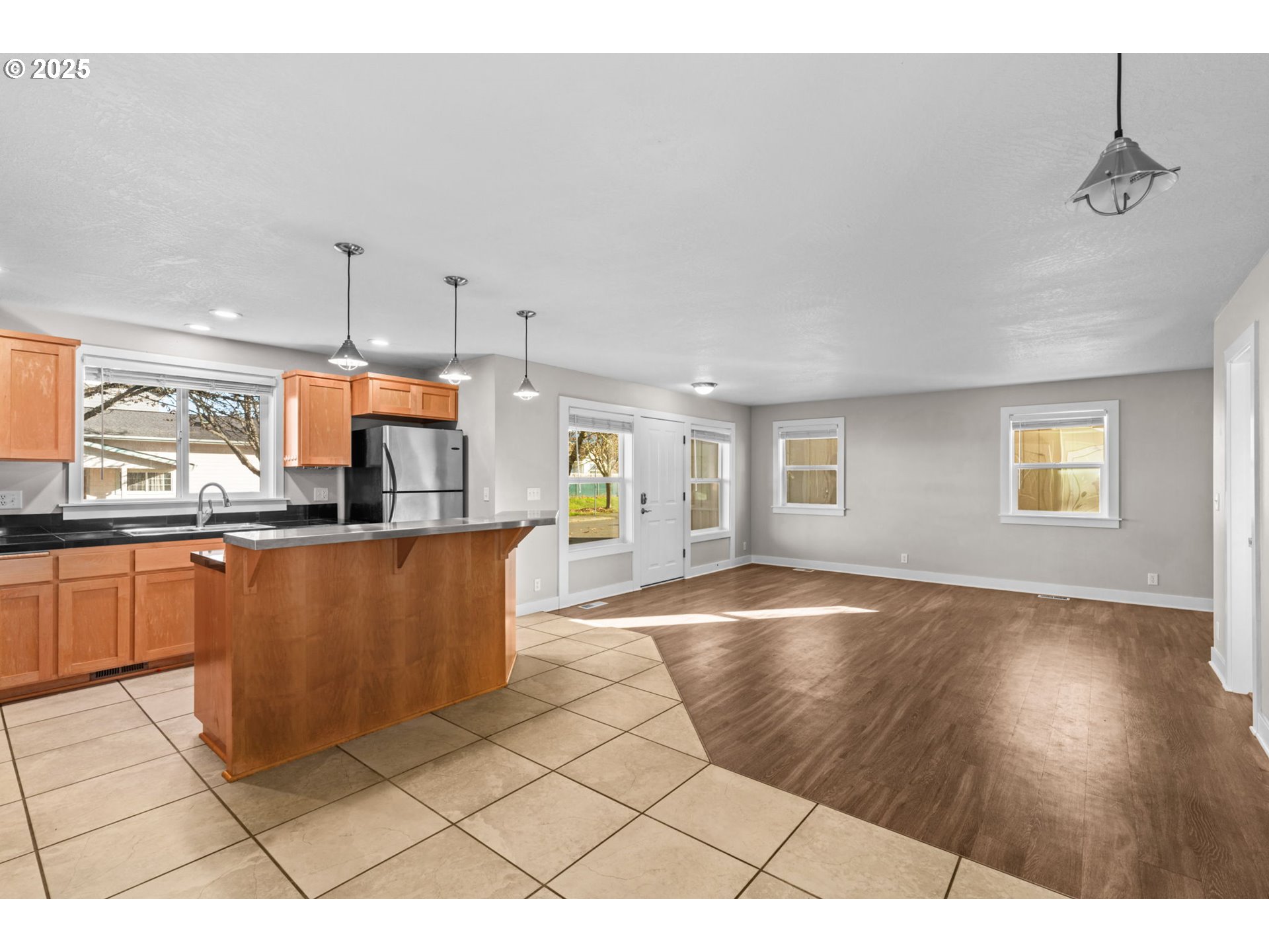 1072 53rd Street Springfield, OR 97478 - Photo 15 of 32 a open kitchen with stainless steel appliances kitchen island granite countertop a refrigerator a sink a stove and oven