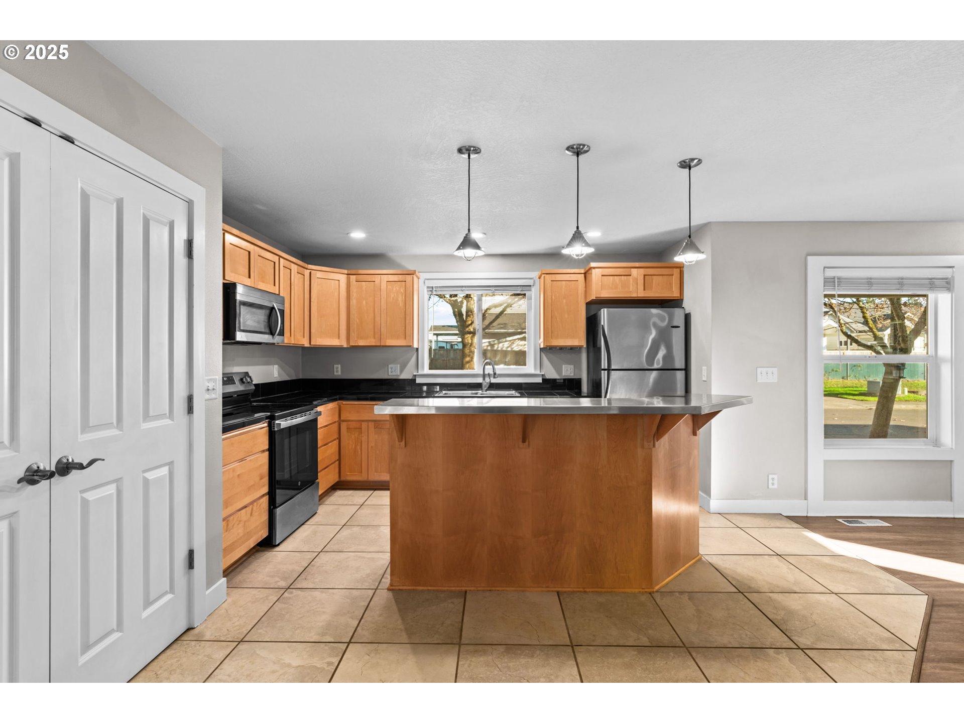 1072 53rd Street Springfield, OR 97478 - Photo 16 of 32 a kitchen with granite countertop a stove a sink and a refrigerator