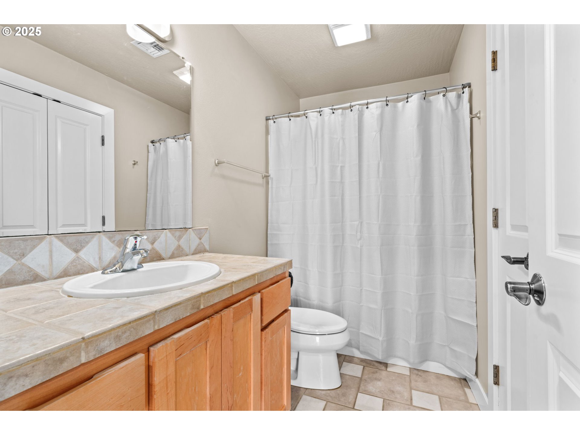1072 53rd Street Springfield, OR 97478 - Photo 20 of 32 a bathroom with a granite countertop sink and a mirror