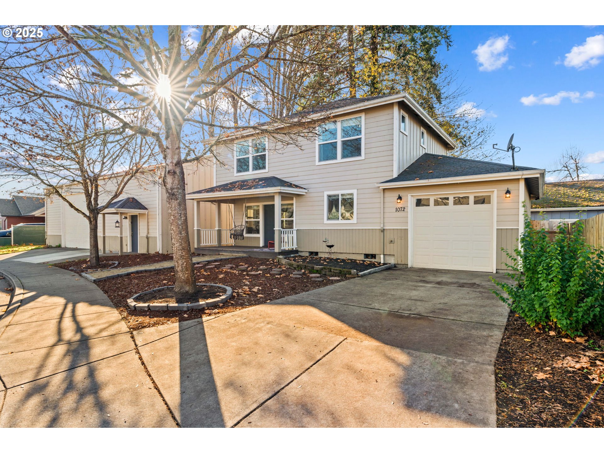 1072 53rd Street Springfield, OR 97478 - Photo 2 of 32 a view of a white house with a large tree