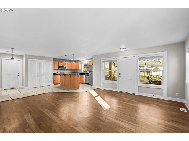 a view of a kitchen with an empty space and a window