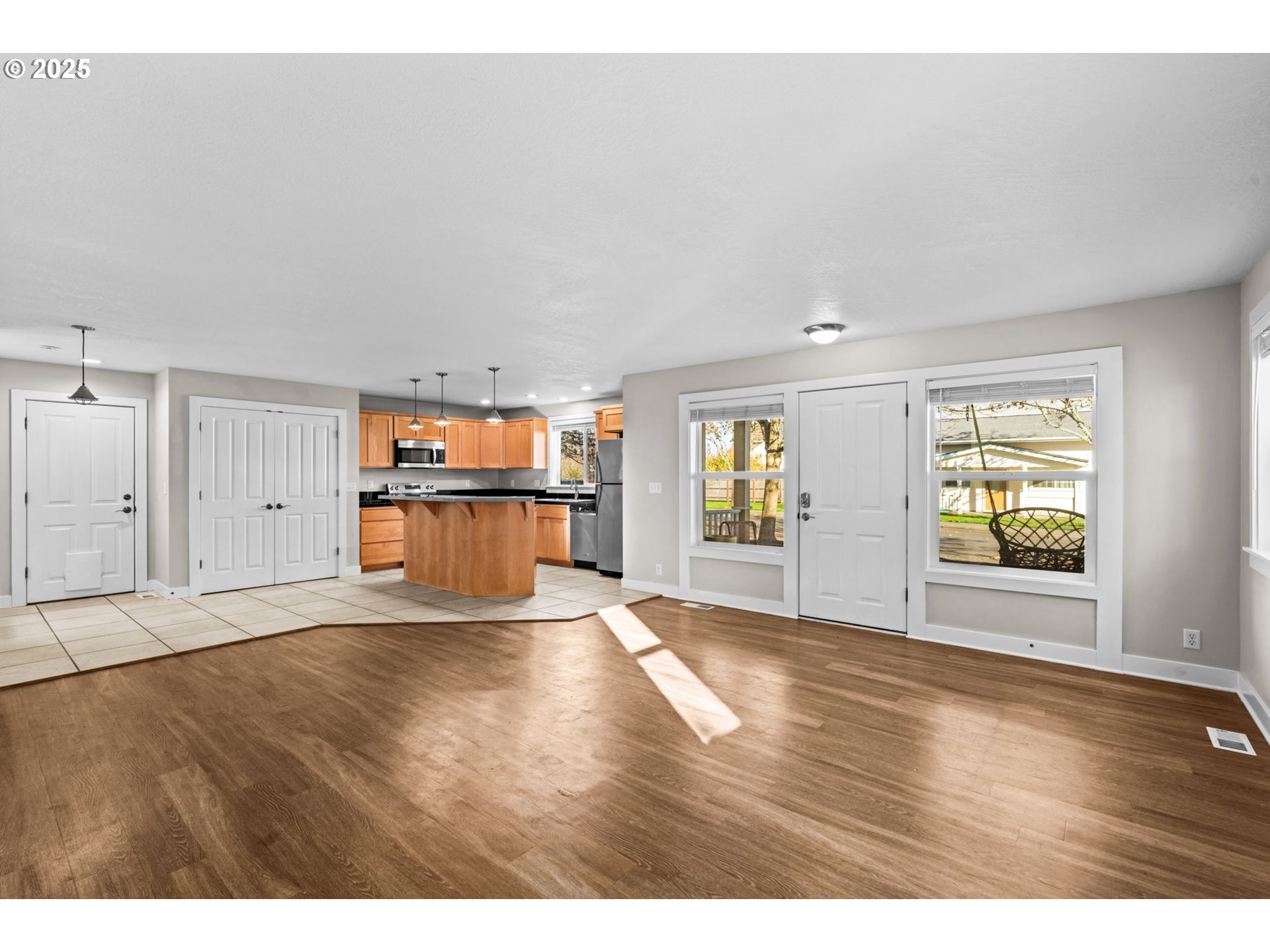 1072 53rd Street Springfield, OR 97478 - Photo 8 of 32 a view of an empty room with wooden floor and a window