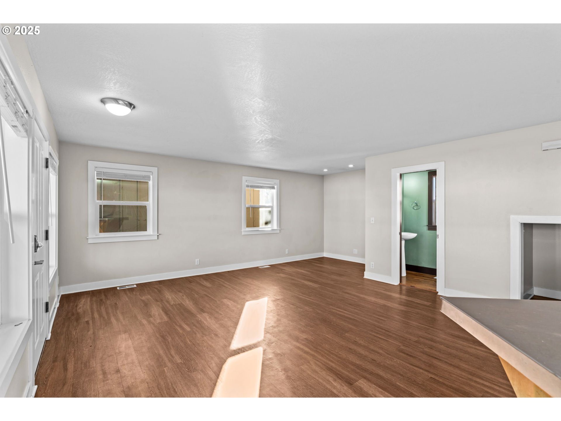 1072 53rd Street Springfield, OR 97478 - Photo 10 of 32 a view of an empty room with window and wooden floor