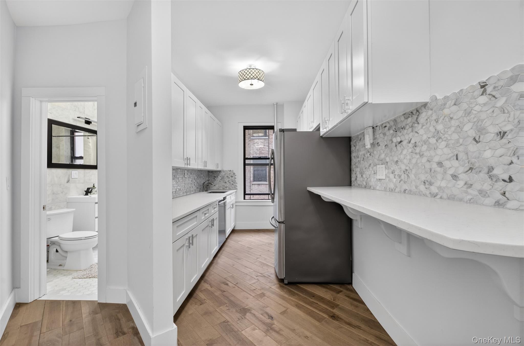 812 Riverside Drive, Unit 42 Manhattan, NY 10032 - Photo 11 of 19 a kitchen with cabinets and wooden floor