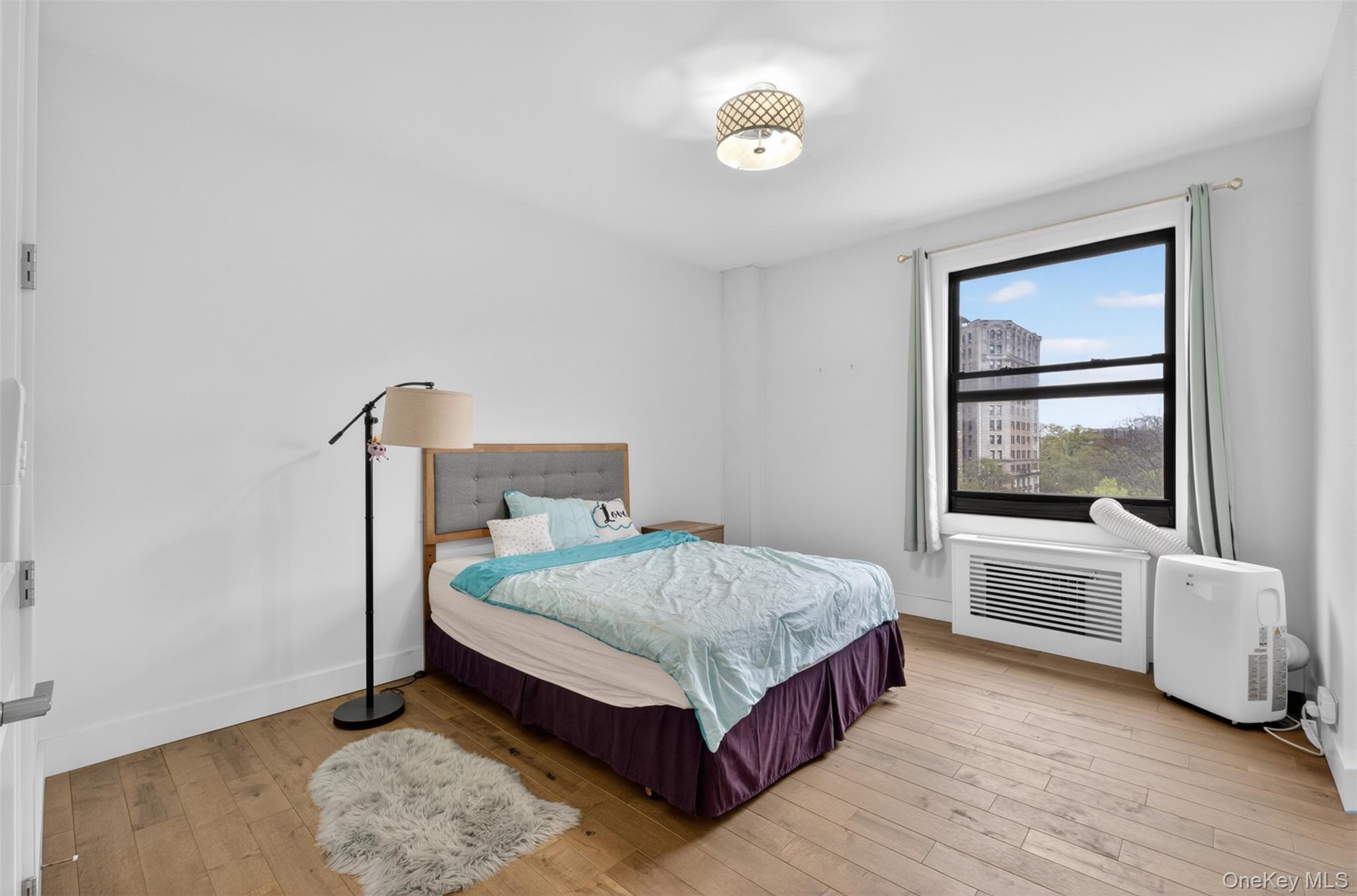 812 Riverside Drive, Unit 42 Manhattan, NY 10032 - Photo 14 of 19 a bedroom with a bed and window