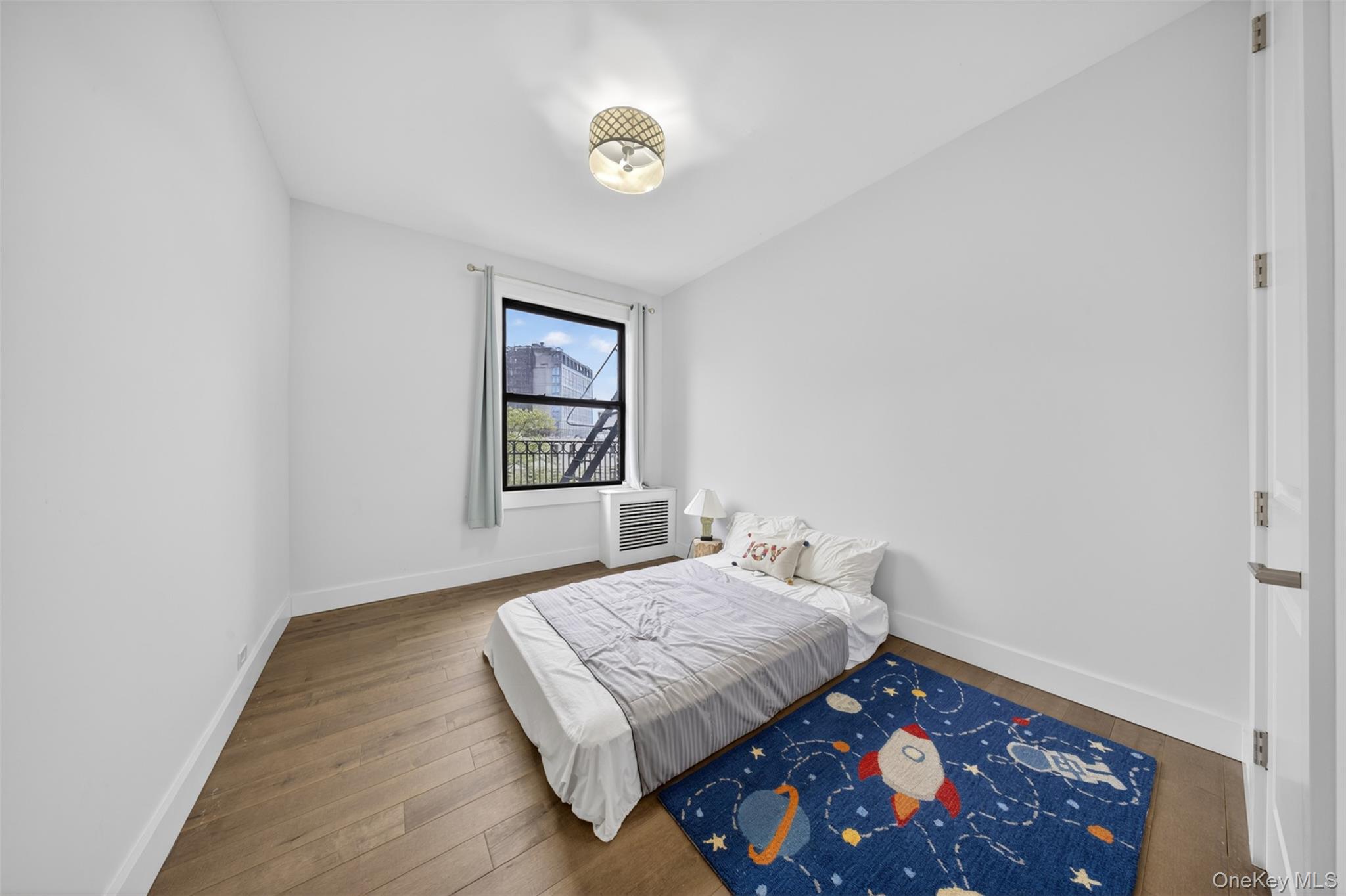 812 Riverside Drive, Unit 42 Manhattan, NY 10032 - Photo 15 of 19 a bedroom with a bed and a window